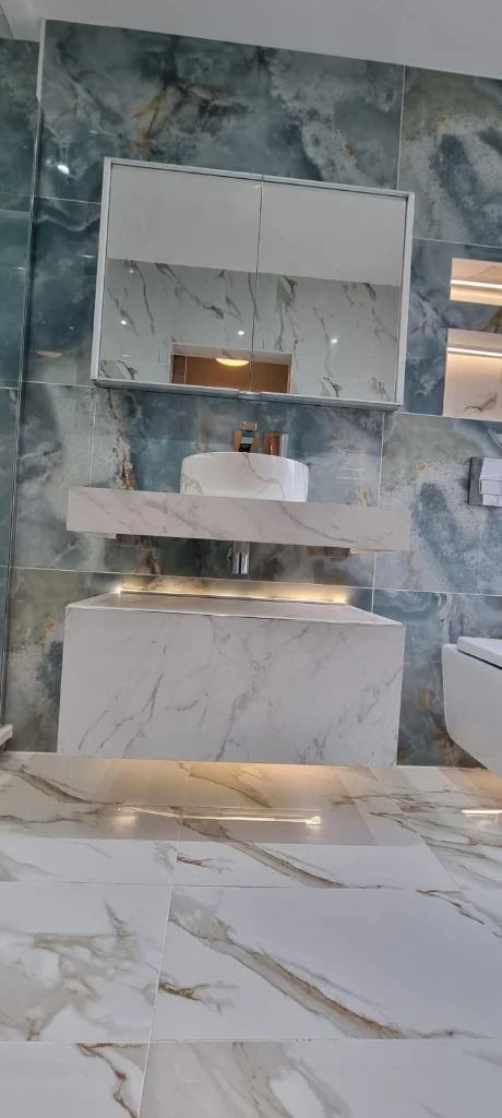 Wall-hung basin, recessed mirror and tiled feature wall in Blyth