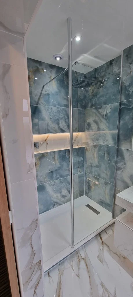 Recessed backlit mirror and wall-hung basin in Blyth