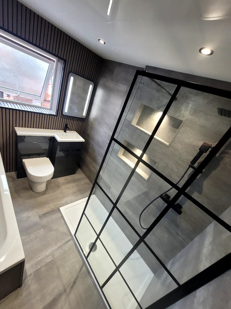 Walk-in shower with black screen and anthracite vanity unit in Boldon