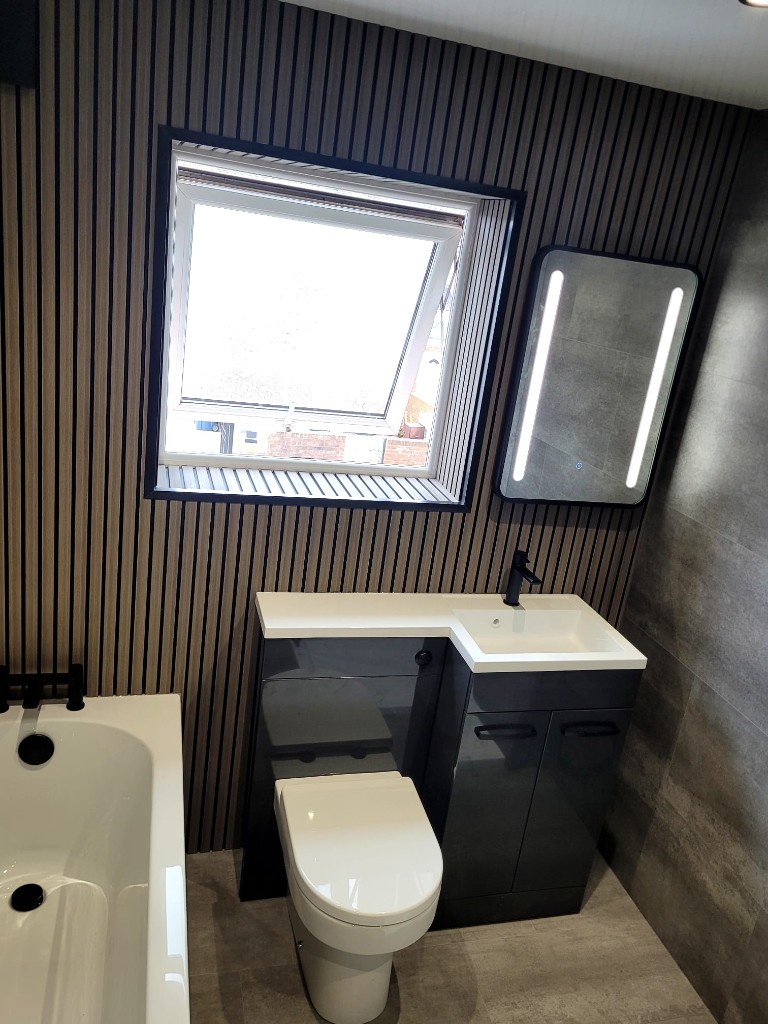 Vanity unit and window set into wood slat wall in Boldon