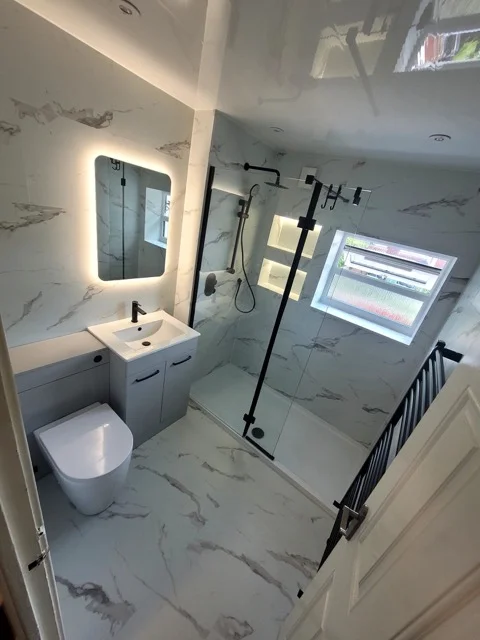 Walk-in shower and vanity in a Ramsbottom bathroom with marble-effect SPC tiling