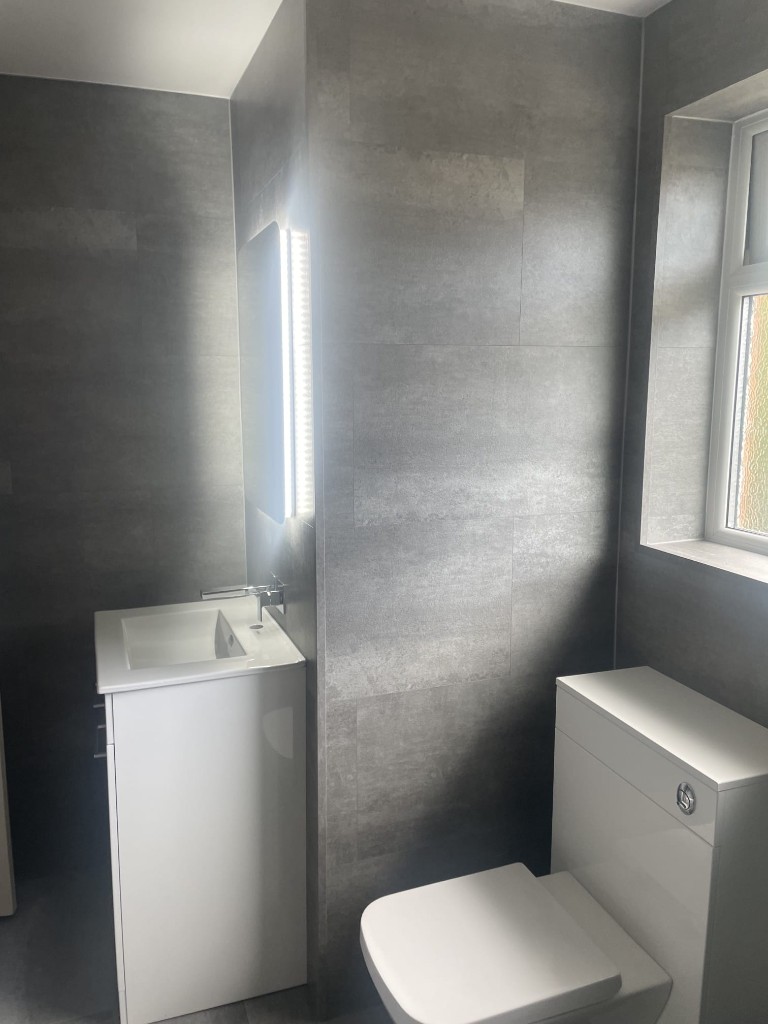 White vanity and back-to-wall toilet with LED mirror in Sacriston