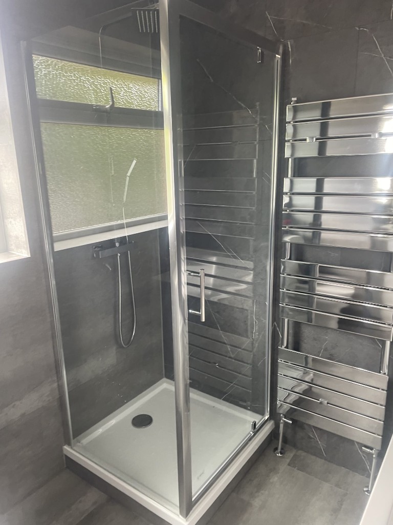 Corner shower enclosure with rainfall head in a Sacriston bathroom