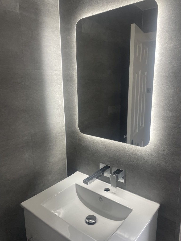 LED backlit mirror and wall-mounted tap in a Sacriston bathroom
