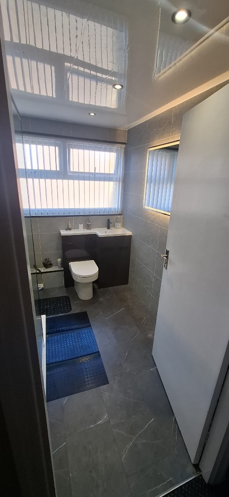 Dark vanity unit with basin, toilet and LED mirror in South Shields