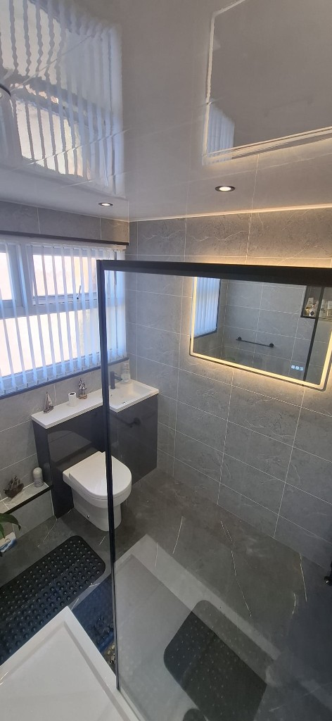Back-to-wall toilet and LED backlit mirror with black tap in South Shields