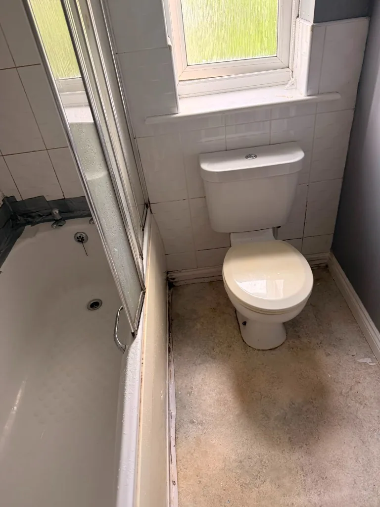 Dated bathroom toilet and window wall before renovation in Tow Law, Durham