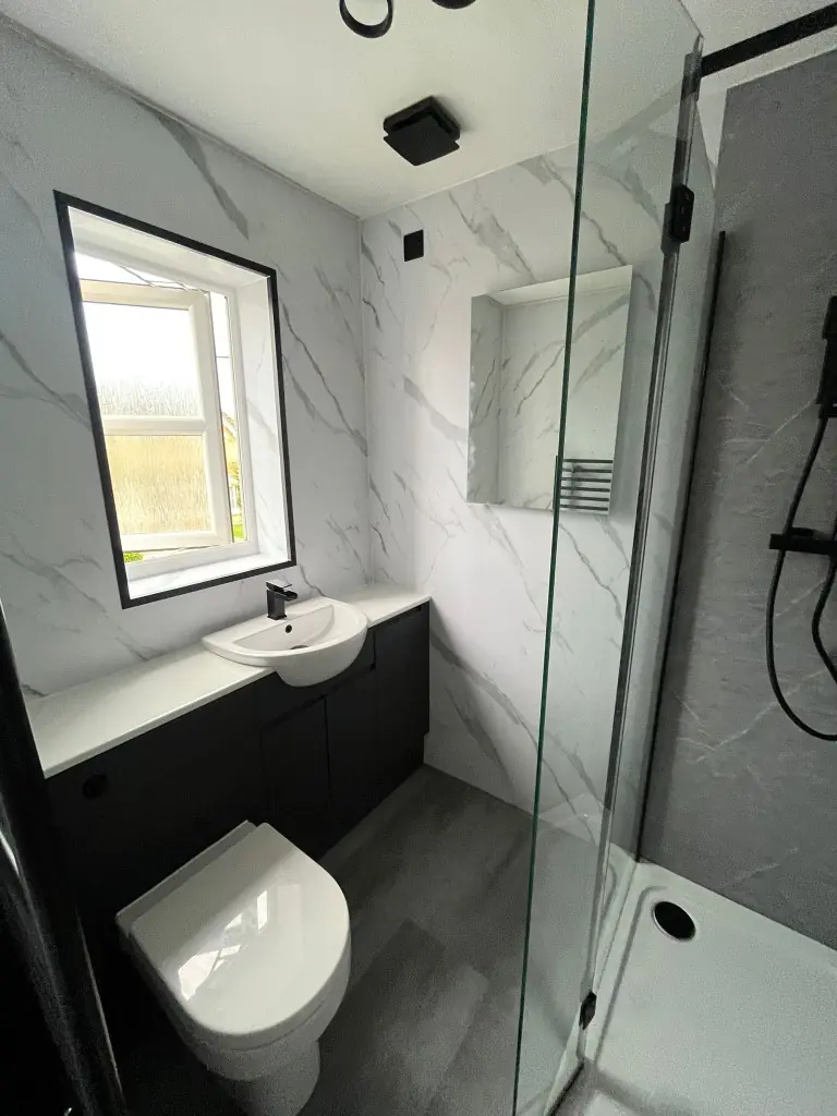 Spennymoor bathroom with grey shower panels, white cladding, SPC flooring and semi-recessed basin