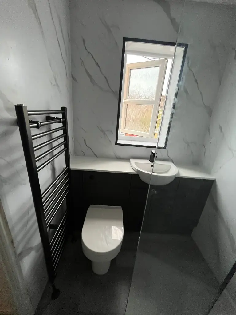 Dark fitted vanity with white semi-recessed basin, matte black tap and heated towel rail in Spennymoor