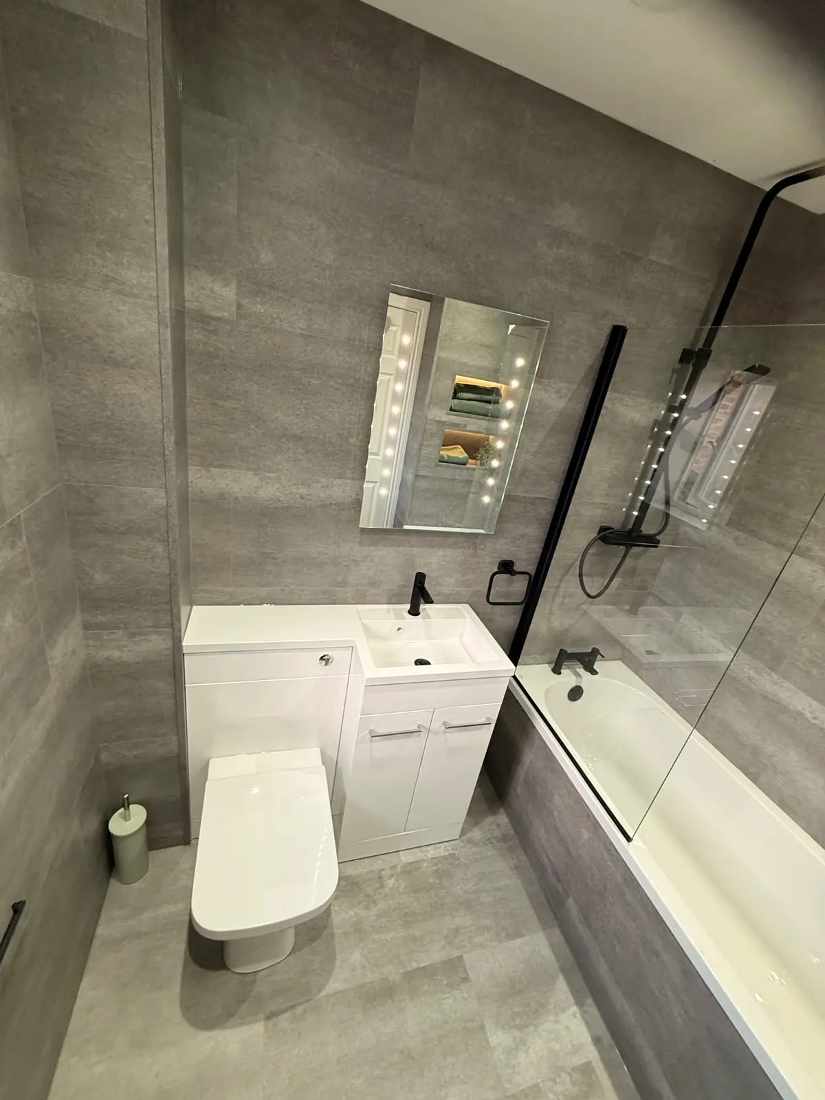 Overhead view of combi vanity, LED mirror and bath with black fittings in Chester-le-Street
