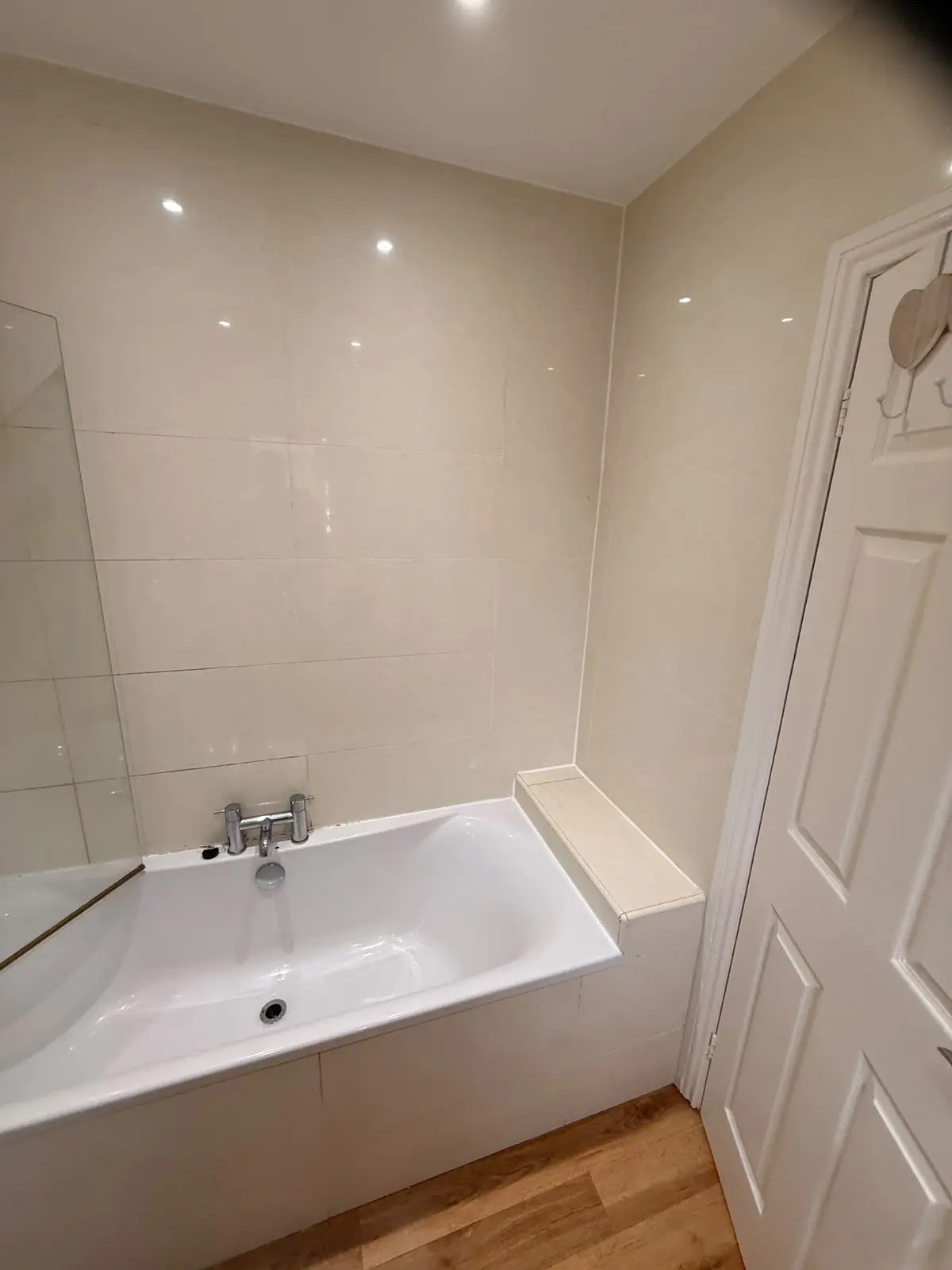 Built-in bath with boxed tiled end wall before renovation in Chester-le-Street