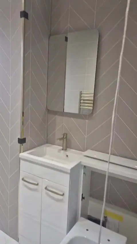 Vanity and herringbone feature wall mid-install with the toilet area still open in Darlington