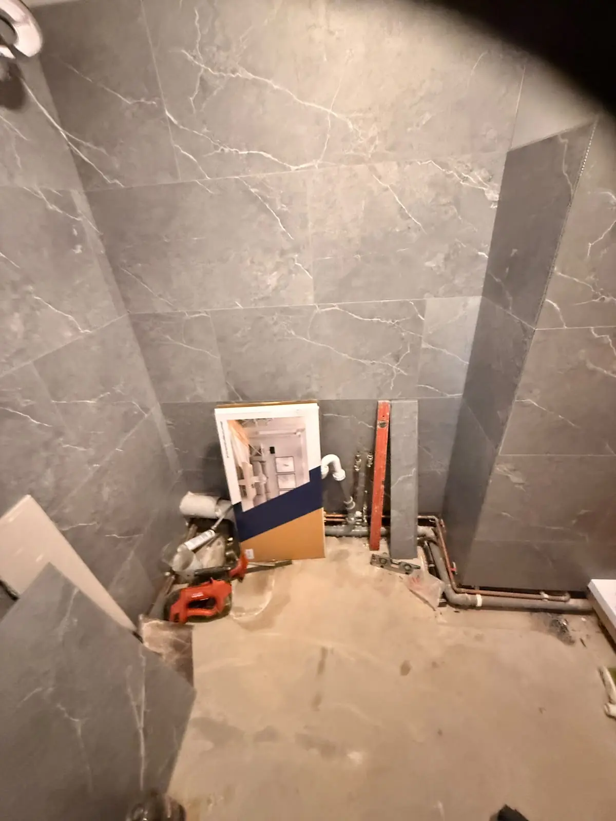 SPC wall tiling complete with exposed plumbing before floor finish in Durham