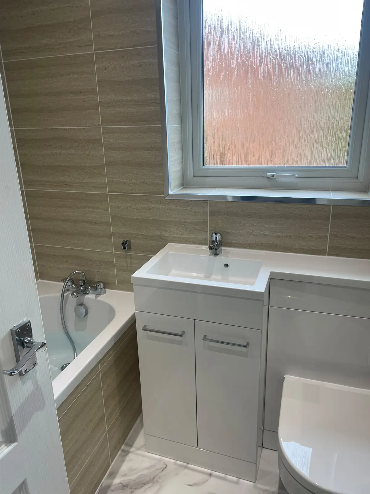 Upstairs bathroom with bath, white vanity unit and Murcia wall cladding