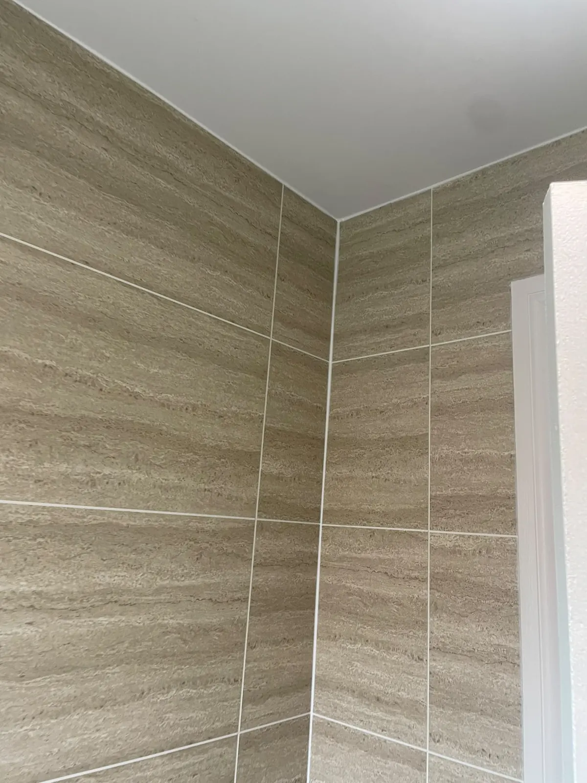 Large-format Murcia wall cladding in the upstairs bathroom