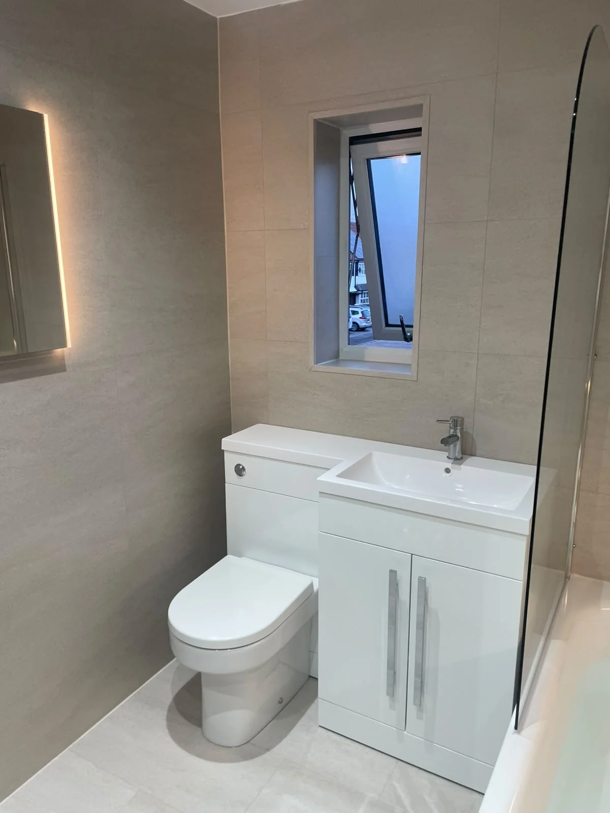White vanity, basin and toilet with uniform SPC tiling in Billingham
